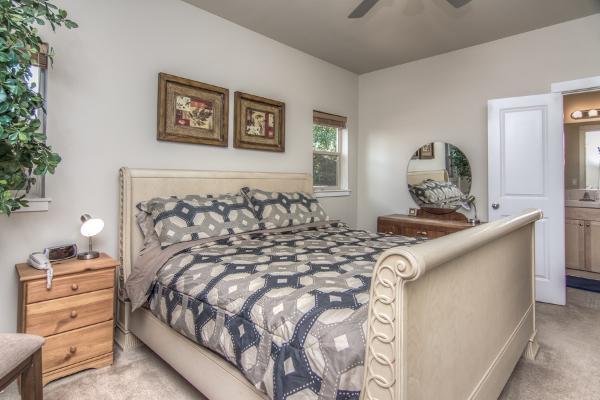 Master suite with king-size bed has its own full bathroom with large walk-in shower.