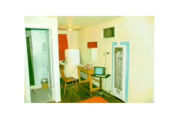 Room 6 long ago.  The bathtub is now located in this corner, and the TV will be a substantial upgrade from this black & white unit!