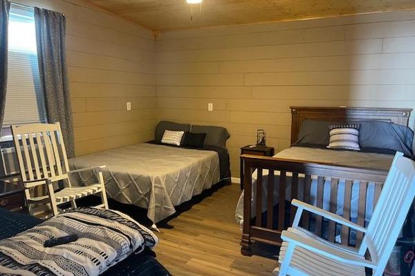 room with 2 queen beds and twin