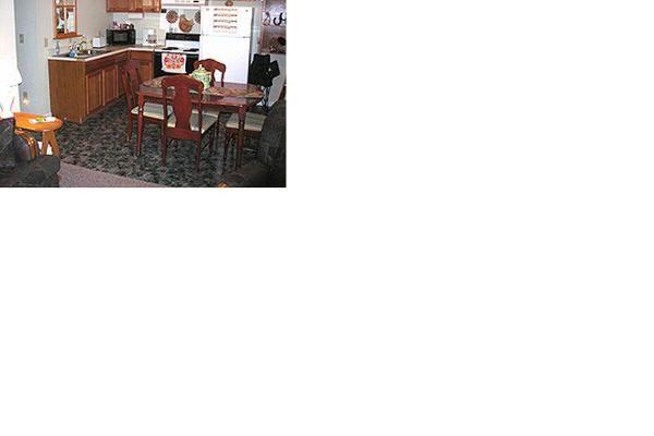 Full kitchen with stove, refrigerator, microwave, coffeemaker, cookware & tableware.