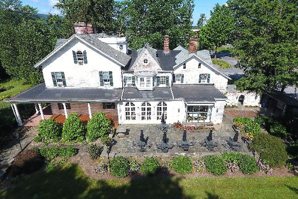 East view drone photo (terrace with tables, chairs & umbrellas)