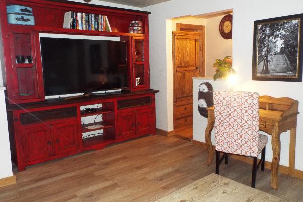 Living room with 60 inch flat TV,wooden desk