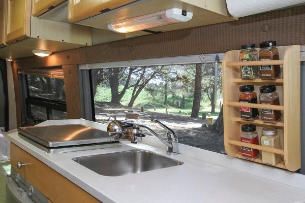 Kitchen with 2 burner stovetop, fridge, toaster oven/micro and sink