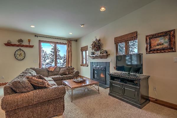 living area with flat screen TV and fireplace 