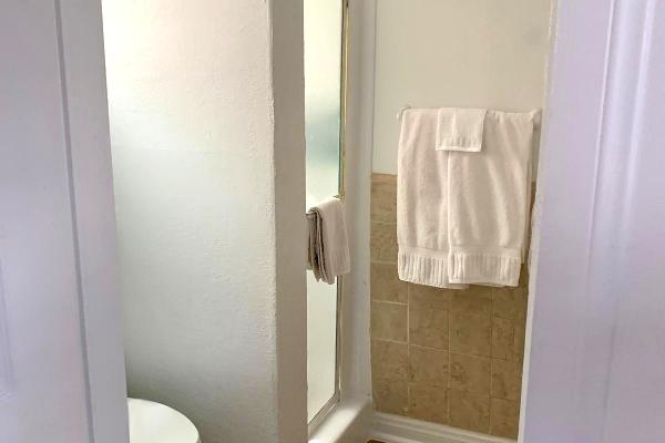 Bathroom with walk-in shower.