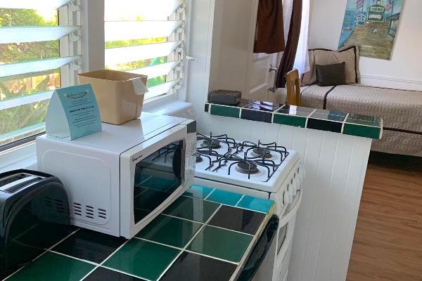 Kitchen with microwave, refridgerator, and stove.