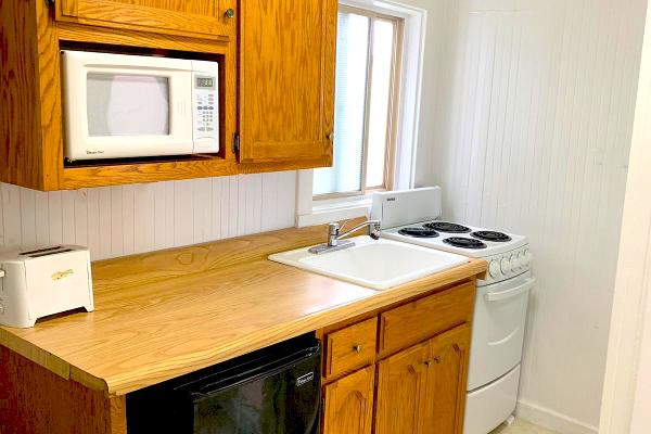 Kitchen with stove, oven & microwave.