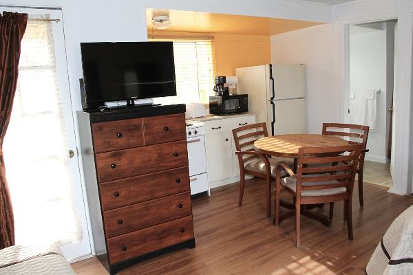 Table for four, new plasma TV & kitchen in front.