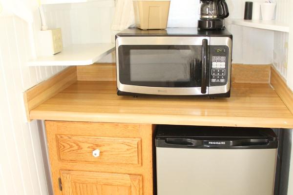 Kitchenette with microwave, refrigerator & coffee maker.