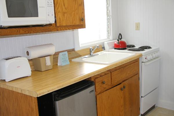 Kitchen with microwave, refrigerator, oven & stove.