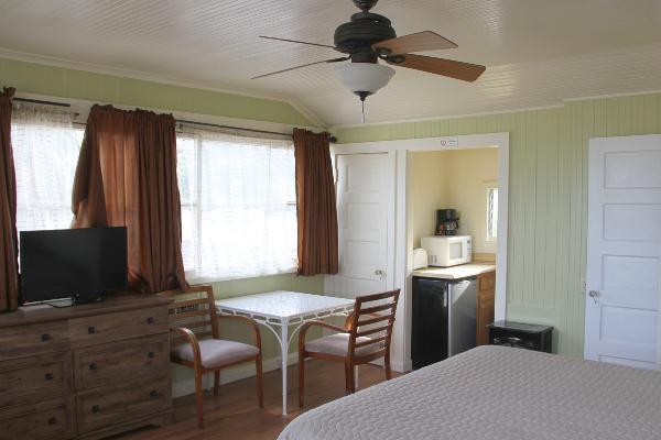 Table for two, TV & kitchenette in back.