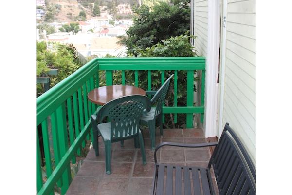 Outdoor seating for two on balcony.