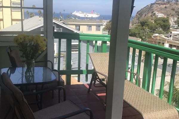 Outdoor seating with island views on balcony.