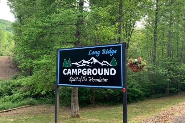 Paved entrance to hard packed gravel throughout the campground.