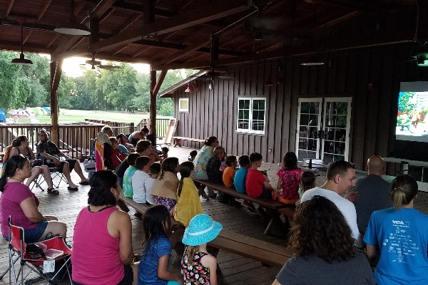 Campers enjoy an evening movie on the deck