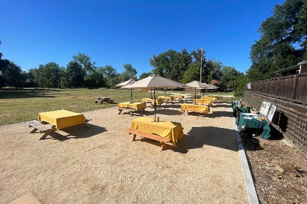 The sunny picnic area on the backside of the lodge includes picnic tables.