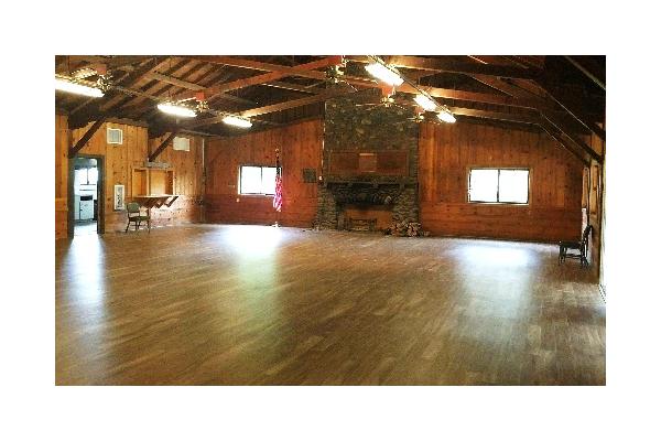 Rustic knotty pine walls, high vaulted ceilings, exposed beams and new flooring. 