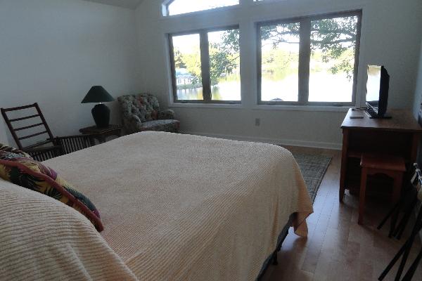 Second floor front bedroom with queen bed and river view