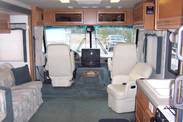 Large Living with couch, dinette, leather chairs, very spacious due to slide-out