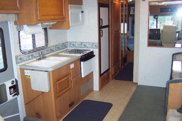 Full Kitchen leads to Hallway with large pantry and closet w/drawers