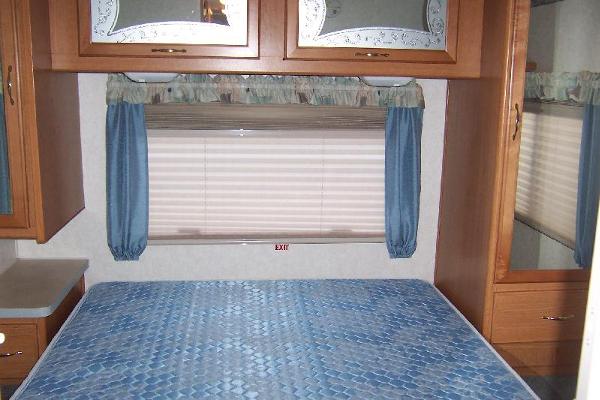 Master Bedroom with Queen Island Bed, corner TV Shelf, plenty of cabinet space