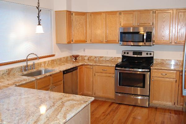 Spacious kitchen with granite counters and wood floors